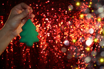 beautiful green Christmas tree is lying on your hand on a shiny background