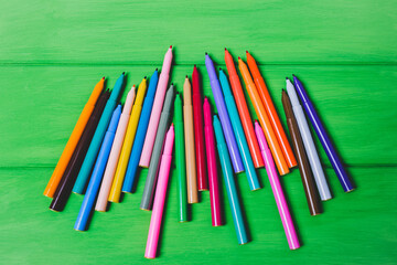 Color markers on a green background.