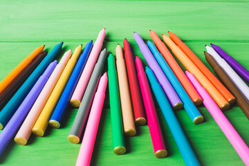 Color markers on a green background.