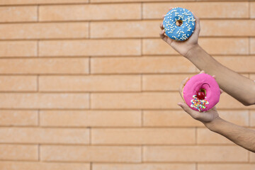 Dessert, fast food, sweets and people concept - Close-up of a pink doughnut with red cherry and...