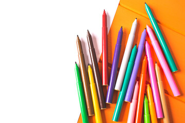 Blank white paper and color markers on wooden table.