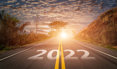 2022 written on highway road. Empty asphalt road and beautiful sunrise sky background. Concept of...