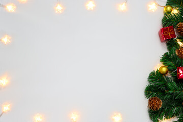 Christmas decoration. Frame of christmas light, branch christmas tree, and christmas decorations on  white background with space for text. Top view, flat lay