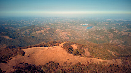 Aerial drone view of countryside hilly landscape in autumn colors.