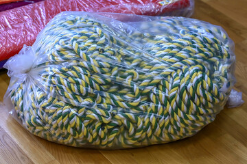 A large skein of multicolored rope. Packaged in a plastic bag. Close-up.