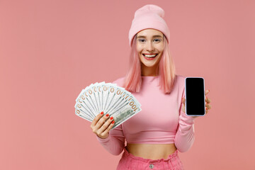 Young woman with bright dyed rose hair in rosy top shirt hat holding fan cash money dollar...