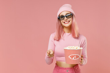 Young woman in 3d glasses hat watch movie film hold bucket of popcorn point finger camera on you...