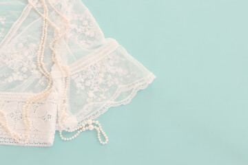 Background of white delicate lace fabric and pearls