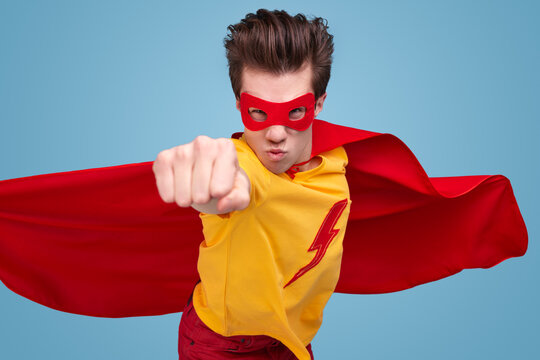 Brave superhero man flying in studio