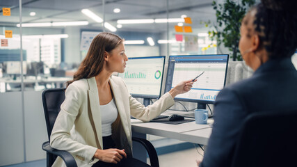 Experienced Manager and Young Employee Discuss Commercial, Financial and Marketing Projects. Young Director Pointing on Screen, Scolds the Employee in Modern Business Office.