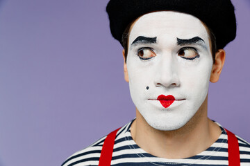 Close up amazing charismatic marvelous magnificent vivid young mime man with white face mask wears striped shirt beret looking aside isolated on plain pastel light violet background studio portrait