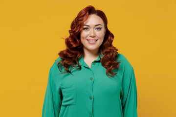 Amazing bright happy young ginger chubby overweight woman 20s years old wears green shirt looking...