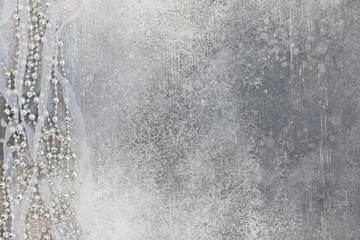 Christmas decoration with shiny beads on a gray background. Top view.