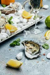 Oysters on the half shell. Fresh oysters served with cocktail sauce and fresh lemons. Oyster dinner in restaurant