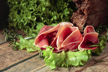 Prosciutto with rosemary and fresh lettuce salad.