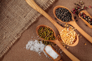 Various raw lentils with salt and pepper.