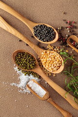 Various raw lentils with rosemary, salt and pepper.