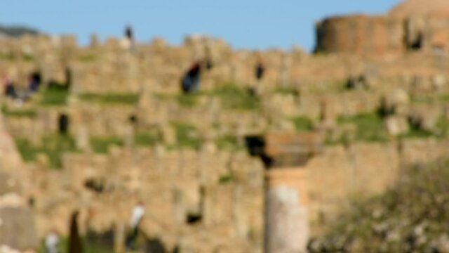 Blurred group of people walking on Roman ruins in Djemila, Setif, Algeria