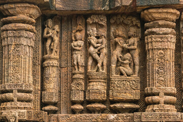 Temple platform of Jagamohana carved with  erotic couples, young women flaunting their beauty in poses, nagas, vyalas, soldiers, elephants, court scenes Sun Temple Konark, Odisha, India.