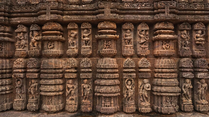 Carvings of  musicians and dancers that almost completely cover the platform, walls and pillars of the hall on Bhoga Mandapa or the dance hall, Sun Temple, Konark, India.