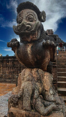 Rock-cut statue of huge Lion riding over couching elephant at entrance of  Bhoga Mandapa of Sun...