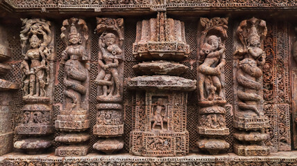 Temple platform of Jagamohana carved with  erotic couples, young women flaunting their beauty in...