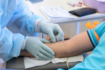 bone marrow donation. blood transfusion. hand in medical glove injects needle, blood sampling from a vein. intravenous medication - obrazy, fototapety, plakaty