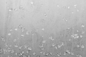Frost on the window, Natural texture on glass with frozen pattern. Copy space, natural background, macro. Beautiful winter background