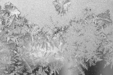 Frost on the window, Natural texture on glass with frozen pattern. Copy space, natural background, macro. Beautiful winter background