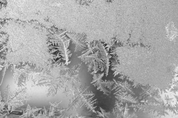 Frost on the window, Natural texture on glass with frozen pattern. Copy space, natural background, macro. Beautiful winter background