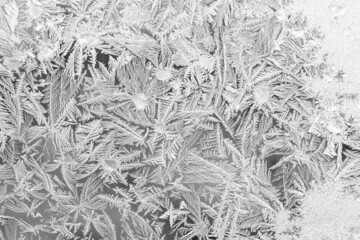 Frost on the window, Natural texture on glass with frozen pattern. Copy space, natural background, macro. Beautiful winter background