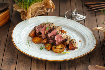 Gourmet beef medallions dish with potatoes and mushrooms