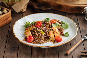 Plate of buckwheat soba noodles with chicken wok