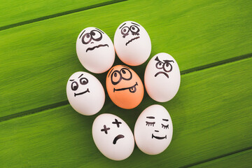 Eggs smileys on a green background.