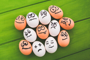 Eggs smileys on a green background.