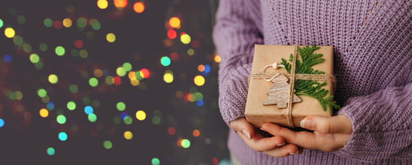 Female hands holding gift box. Christmas and New Year holidays concept. Banner