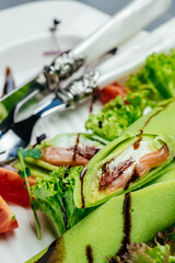 crepes with smoked salmon, spinach and sour cream, Delicious breakfast or snack, Clean eating, dieting, vegan food concept. top view