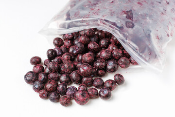 Packages with frozen blueberry on white background, front view.
