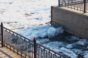 Fragment of the city embankment on the Amur River during the spring ice drift. Needle structure of...