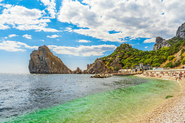 Beautiful seascape with a view of the beach and an extreme suspension bridge on the Diva rock. Simeiz, Crimea