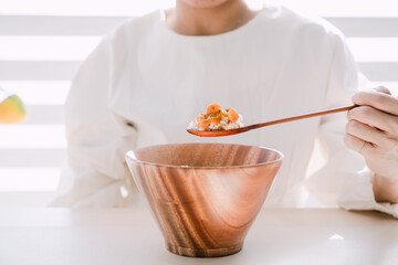 Curry over rice in a wooden bowl.