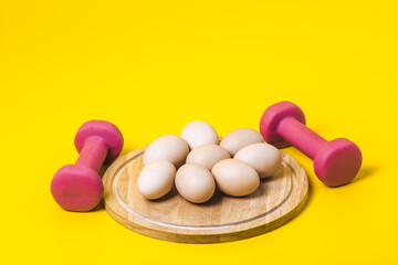 Eggs and a dumbbells, protein for athletes