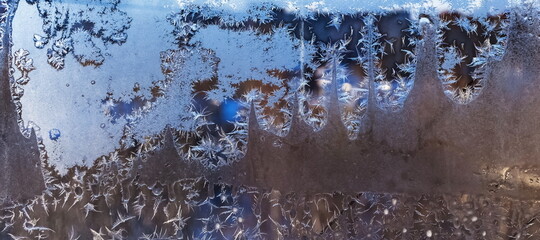 Frosty drawing on the window close-up in winter