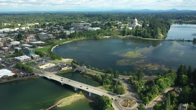 Cinematic 4K aerial dolly in drone shot of the Olympia Yacht Club near the Washington State Capitol Building and Campus, Capitol Lake, with a panoramic view of Historic District in Olympia, Washington