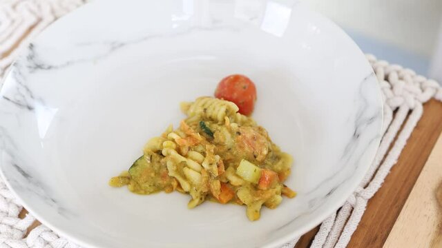 vegan pasta with carrots celeri and fresh pesto sauce, healthy plant-based food