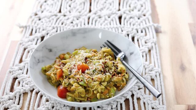 vegan pasta with carrots celeri and fresh pesto sauce, healthy plant-based food