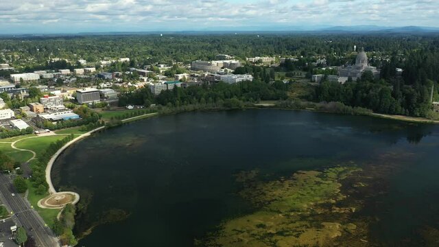 Cinematic 4K aerial drone pan shot of downtown Olympia near the Washington State Capitol Building and Campus, Capitol Lake, with a panoramic view of Historic District in Olympia, Washington