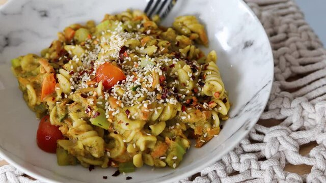 vegan pasta with carrots celeri and fresh pesto sauce, healthy plant-based food