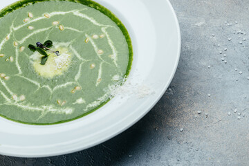 Delicious broccoli cream soup with parmesan in a bowl, . Vegetarian dish. banner, catering menu recipe place for text, top view
