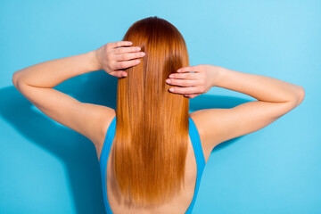 Back view photo red haired woman wearing pretty singlet got straight silky hair isolated pastel blue color background